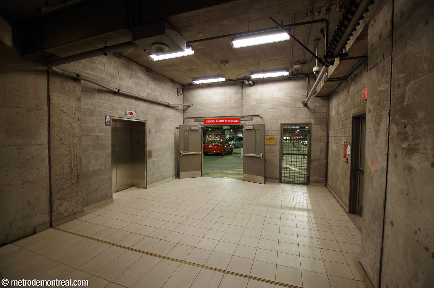 The tunnel from the original ticket hall to the commuter train station was extended to reach the MUHC campus headhouse, and abutted the wall of the hospital’s underground parking garage. While waiting for the new headhouse and tunnel to be completed, underground city access was provided to the hospital via the parking garage. The elevator (left) and stairs (door on the right) lead up to the MUHC campus headhouse.