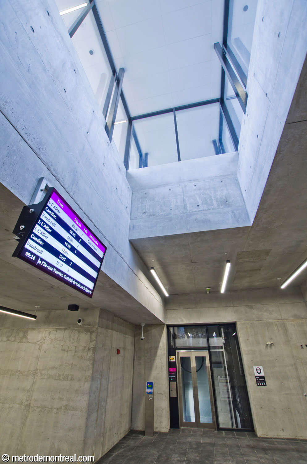 A skylight illuminates the tunnel connecting the new headhouse to the commuter train station, with one of the elevators to the platforms.