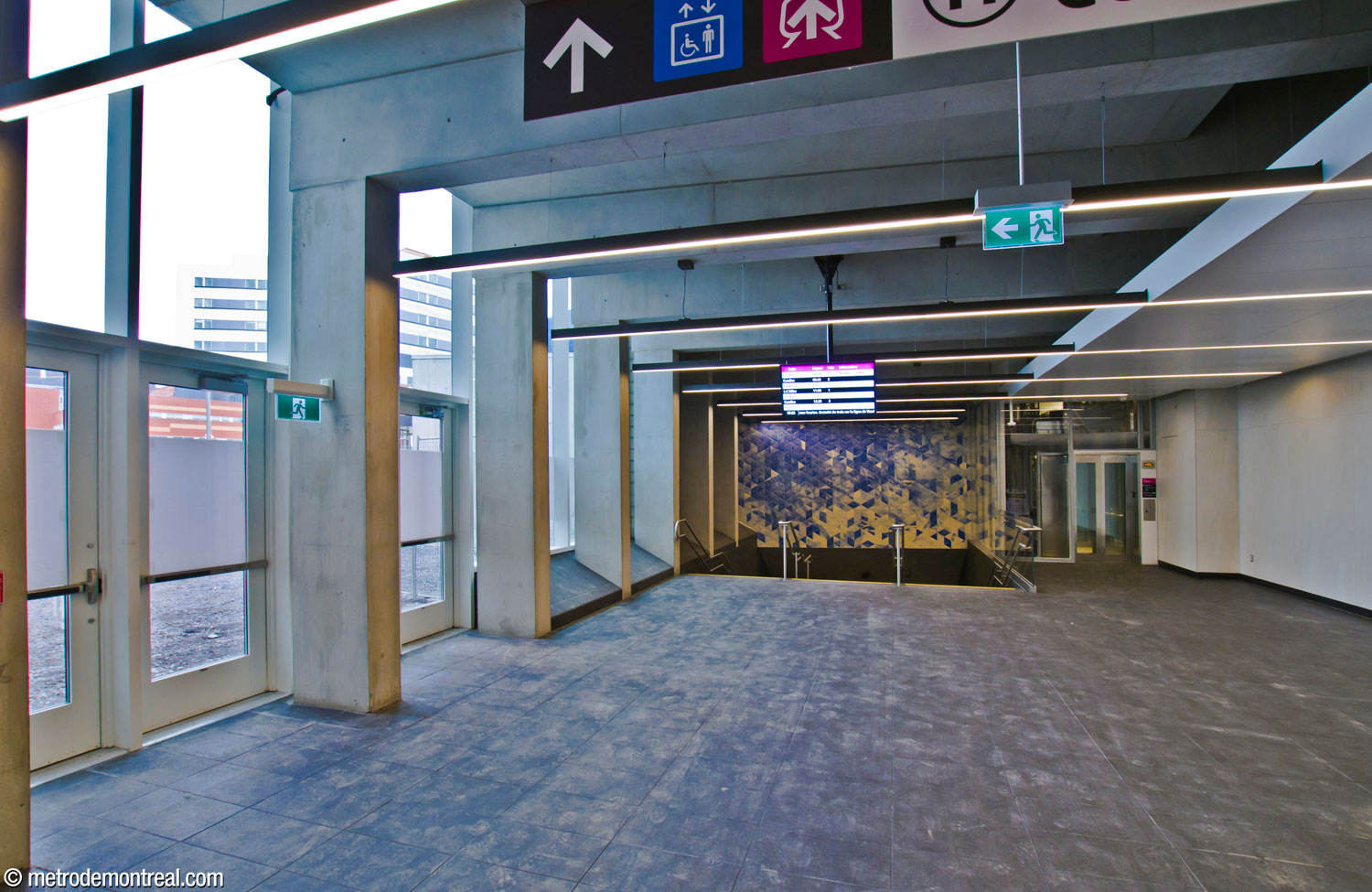 The hallway on the east side of the new headhouse. The stairs and elevator give access to the commuter train station and pedestrian tunnel to the MUHC. Above the stairs is the second segment of Patrick Bernatchez's mural cycle.