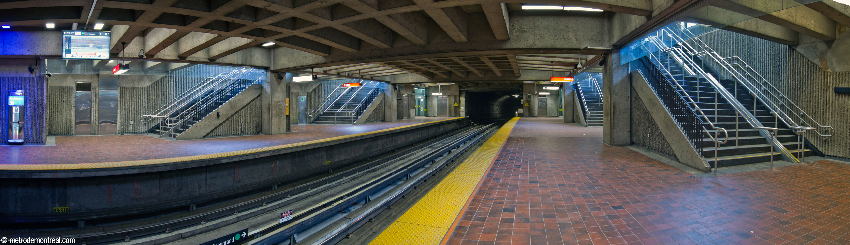 Panorama of the east end of the trainroom, with the four stairwells connecting the platforms to the headhouse; the elevators are beyond the farther stairwells, at the end of the platforms.