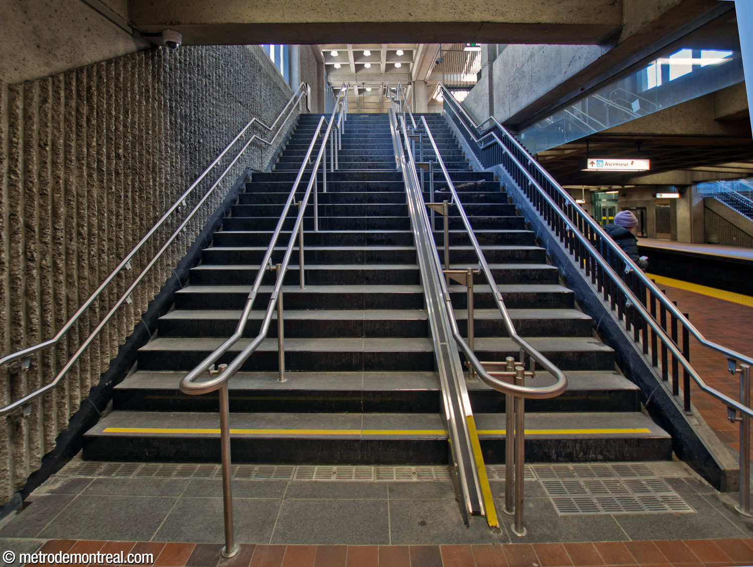 Looking up one of the stairwells from the Angrignon platform. The metal track along the stairs at right is a prototype ramp to facilitate carrying bicycles up the stairs, less relevant now that elevators have been installed.