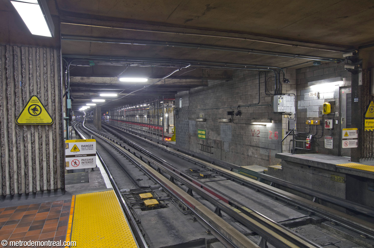 The tunnel just west of the station, heading toward Pie-IX. A short distance beyond the station, the tunnel widens to host a third track at the centre, where an additional train can wait to help manage large passenger volumes after Olympic Park events. On the right side of the tunnel, a spur heads back toward the station, passing north of it to connect with the adjacent Viau attachment centre.