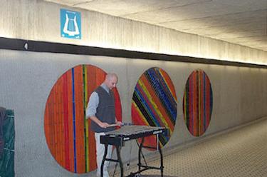 A busker performs at Peel station