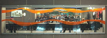 Windows on the orange line platform, with stripes