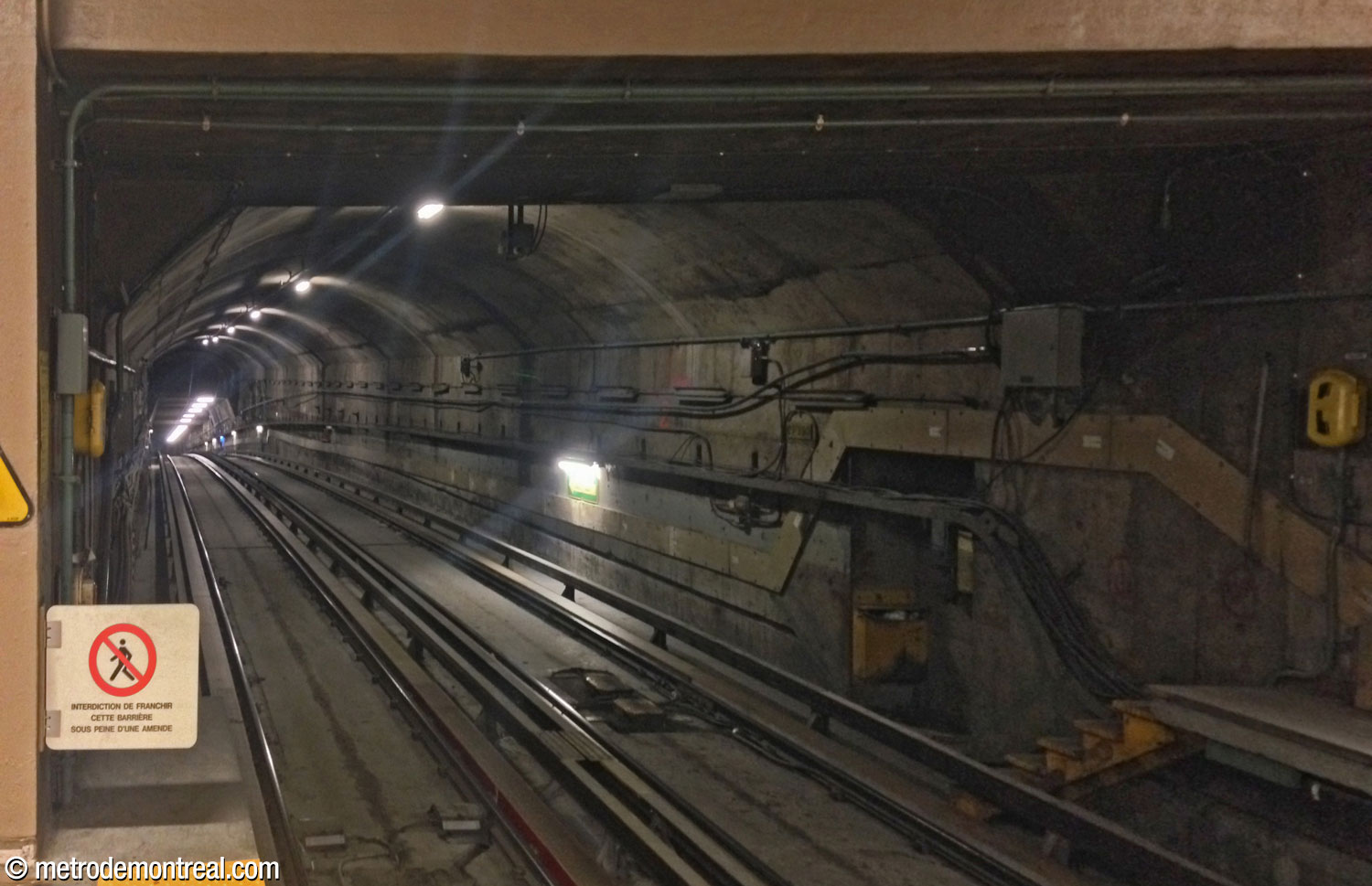 The vault and end wall of the former tail track are visible above the downward slope heading toward Lionel-Groulx.