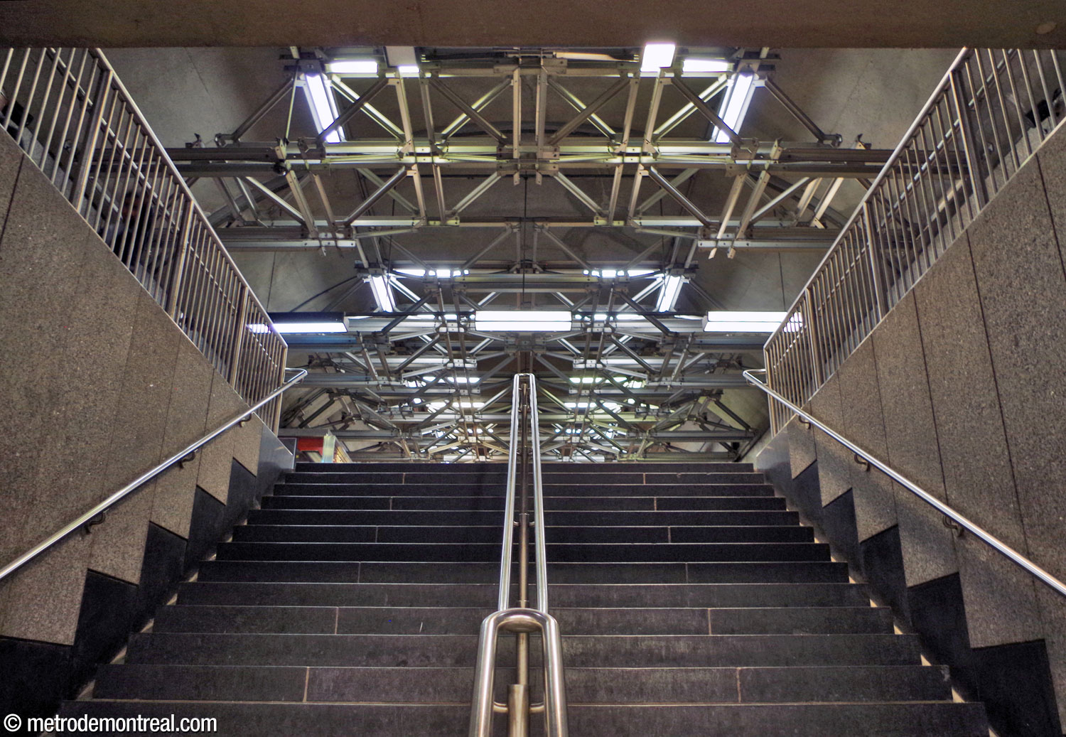 Looking up the stairs from the Saint-Michel platform up to transept level, with the metal spaceframe overhead.
