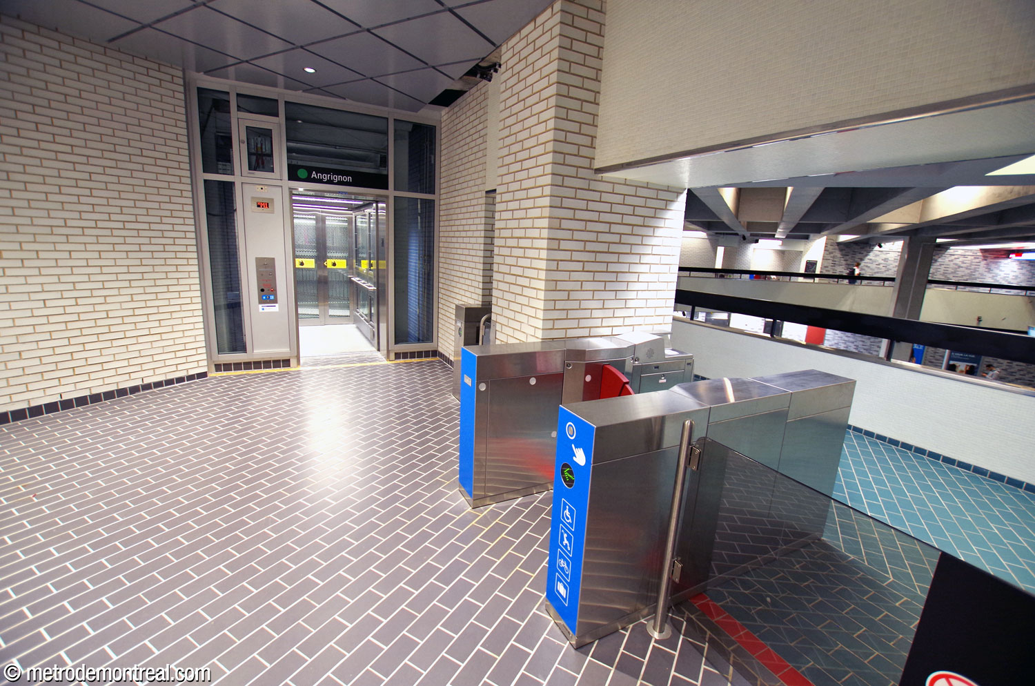 The elevators to the platforms are housed in small, enclosed alcoves off of the walkways, with separate gatelines leading to them.
