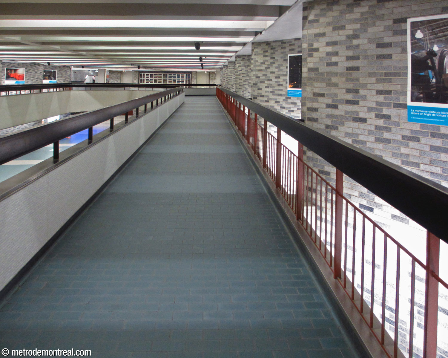 One of the two walkways connecting the east and west ticket halls, seen here facing west. Note how the walkway is suspended from the points of the zigzags.